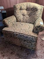 Full front view of floral upholstered armchair