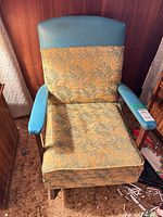 Front view of rocking armchair showing upholstery and frame