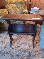 Full view of wood side table showing top surface and integrated lower shelf
