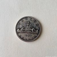 Reverse view showing CANADA DOLLAR, canoe motif, date 1961