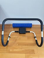 abdominal trainer frame with foam roller placed behind