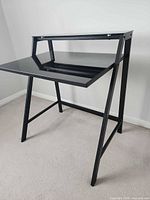 Front view of black metal and glass desk