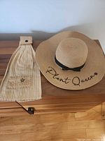 Hat and towel laid flat on wooden surface