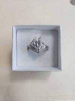 Ring in box showing dove motif front view