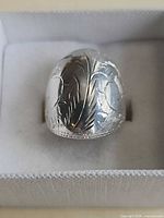 Front view showing engraved floral dome design