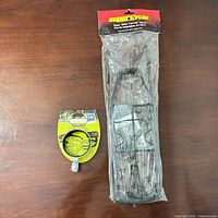 Sealed SuperCycle rack beside packaged Traveler cup holder