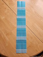 Full view of long sheet showing all 50 teal garbage tags