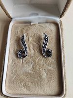 Front view of earrings in case showing marcasite inlay and design