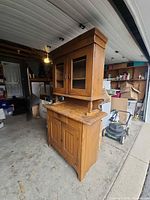 Full view angled of entire wooden hutch showing upper and lower sections