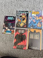 Six bagged comics: four Legends of the Dark Knight issues, Vengeance of Bane, The Tick