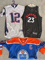 Front view of all three jerseys showing team logos, numbers and colors
