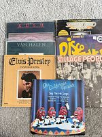 Group shot showing all seven LP sleeves partially stacked