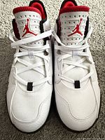 Top view of both shoes showing laces, tongues with red Jumpman logo