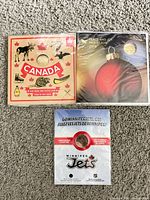 Front of the three sealed coin gift sets