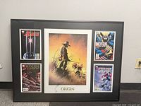 Front view of framed display showing signed Origin print and four comics