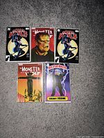 Five bagged Issue #1 comics displayed on floor