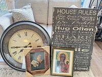 Group shot showing all four wall-hang items: House Rules sign, round wall clock, two framed prints
