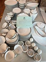 Entire dinnerware set stacked on table