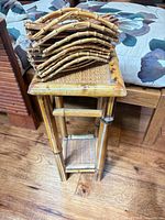 Square bamboo plant stand with accessories stacked on top