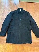 Full view of black overcoat front side