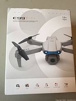 Front of box showing E99 C99 folding camera drone image and features