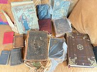 Overview of all books laid out showing variety of sizes and bindings