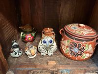 Group shot of all five terracotta pieces inside cabinet