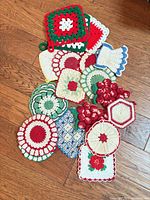 All potholders grouped on floor showing variety