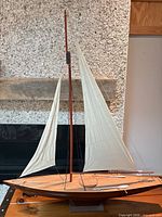 Full view starboard side of wooden model sloop on stand