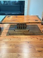 Full view of rectangular wood coffee table with rope pedestal