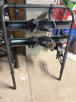 Front view of hitch-mounted 2-bike rack showing twin support rails and frame