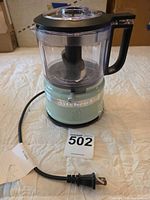 Front view of KitchenAid mini food processor showing base, bowl, blade, lid and power cord