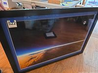 Front view of framed eclipse photograph with blue mat and black frame