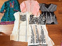 All five tops laid out showing style, color, and detailing