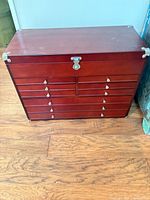 Front view showing drawers, latch and wood finish