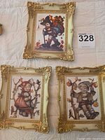 Three framed M.I. Hummel prints in gold frames