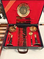 Open case showing full flatware set, bowls, candlesticks, serving pieces