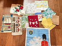 Overview of all tea towels and napkins laid out on floor