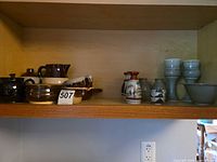Full shelf view showing all stoneware and porcelain pieces together