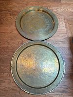 Full view of both brass trays showing size, shape and engravings