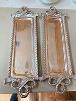 Pair of rectangular polished aluminum trays with rope motif handles