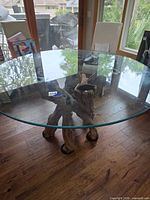 Full view of round glass top on driftwood base