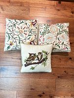 All three embroidered pillows front view