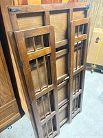 Bookcase folded on side showing slatted mission style sides and overall construction