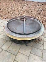 Full view of fire pit with mesh lid in place