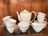Full set showing teapot, six cups, creamer, sugar bowl, stack of saucers