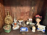 Group shot of all items displayed together inside wooden cabinet