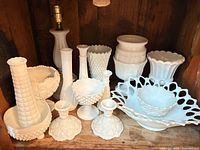 all milk glass pieces arranged together on shelf