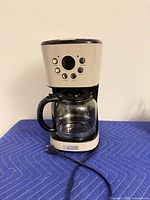 Front view of Haden drip coffee maker with carafe and power cord