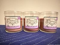 Front view of three pink Benditaroma Aromabeads jar candles
